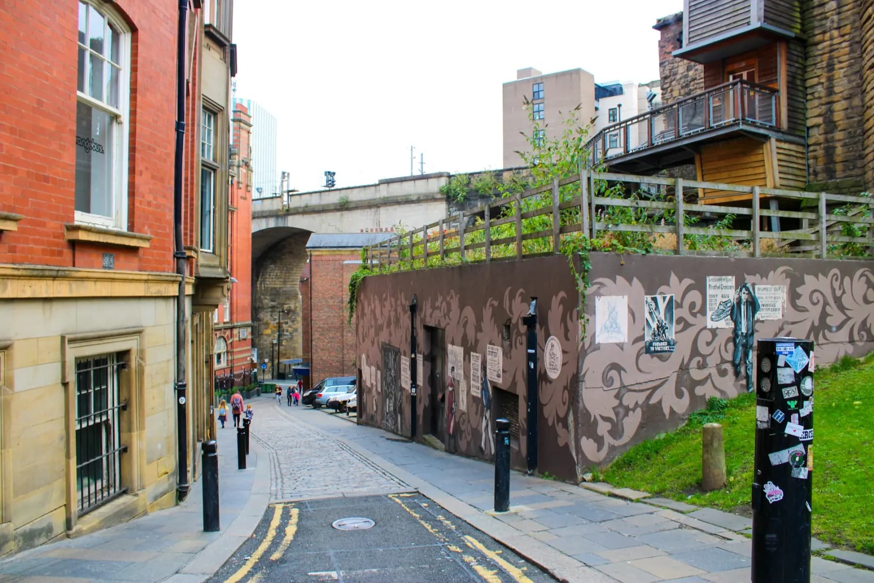 A narrow street of old brick buildings in Newcastle.